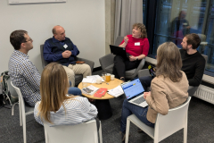 Meeting participants in group discussions on projected secondments